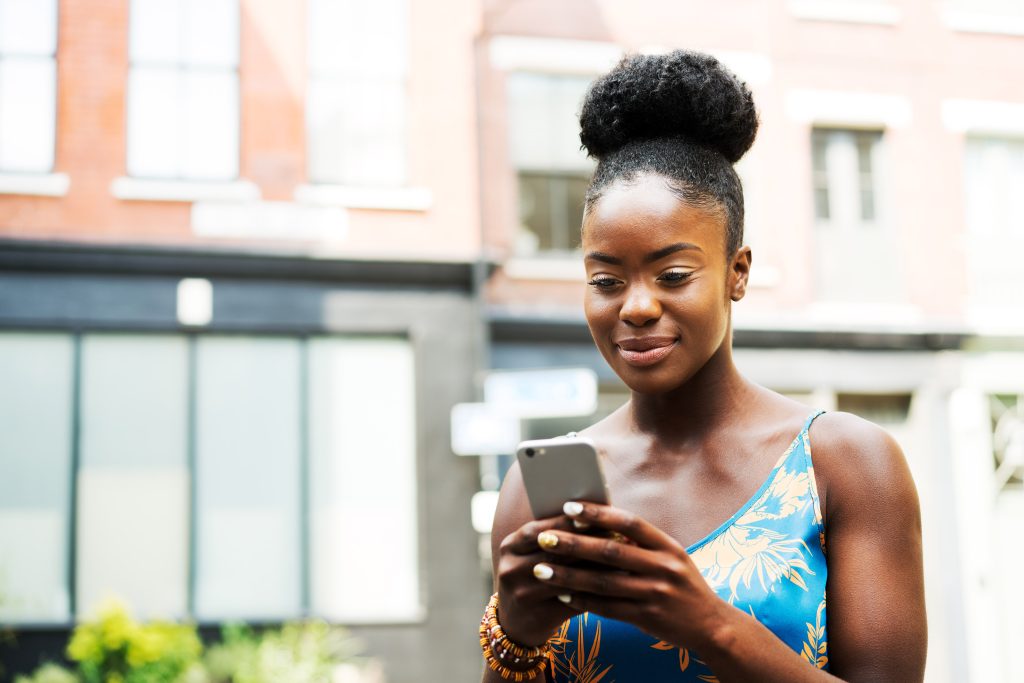 Woman receiving job posting on mobile phone short codes program