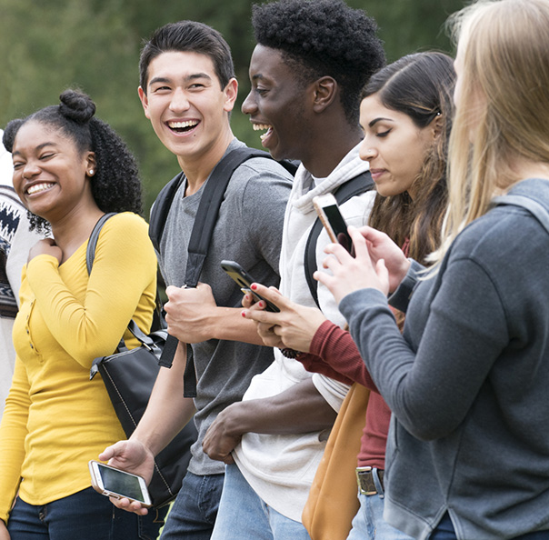 College students walking and using mobile phones short codes program
