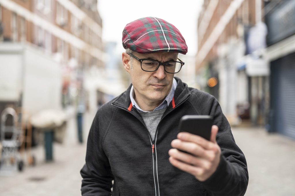 Man looking concerned after receiving fraud alert on smartphone