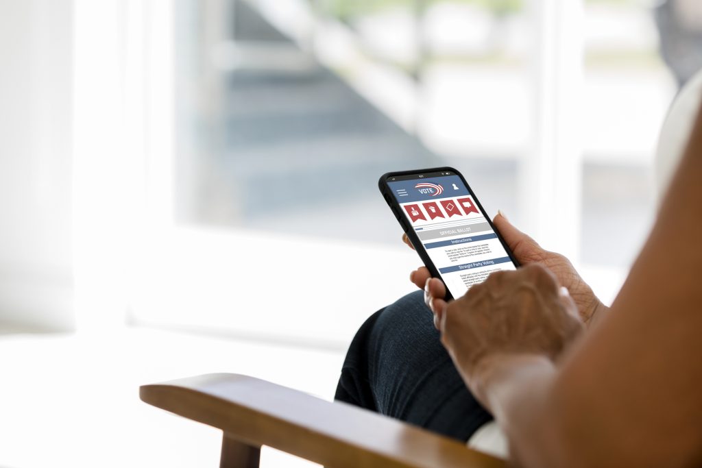 Woman votes online using mobile phone short-codes program